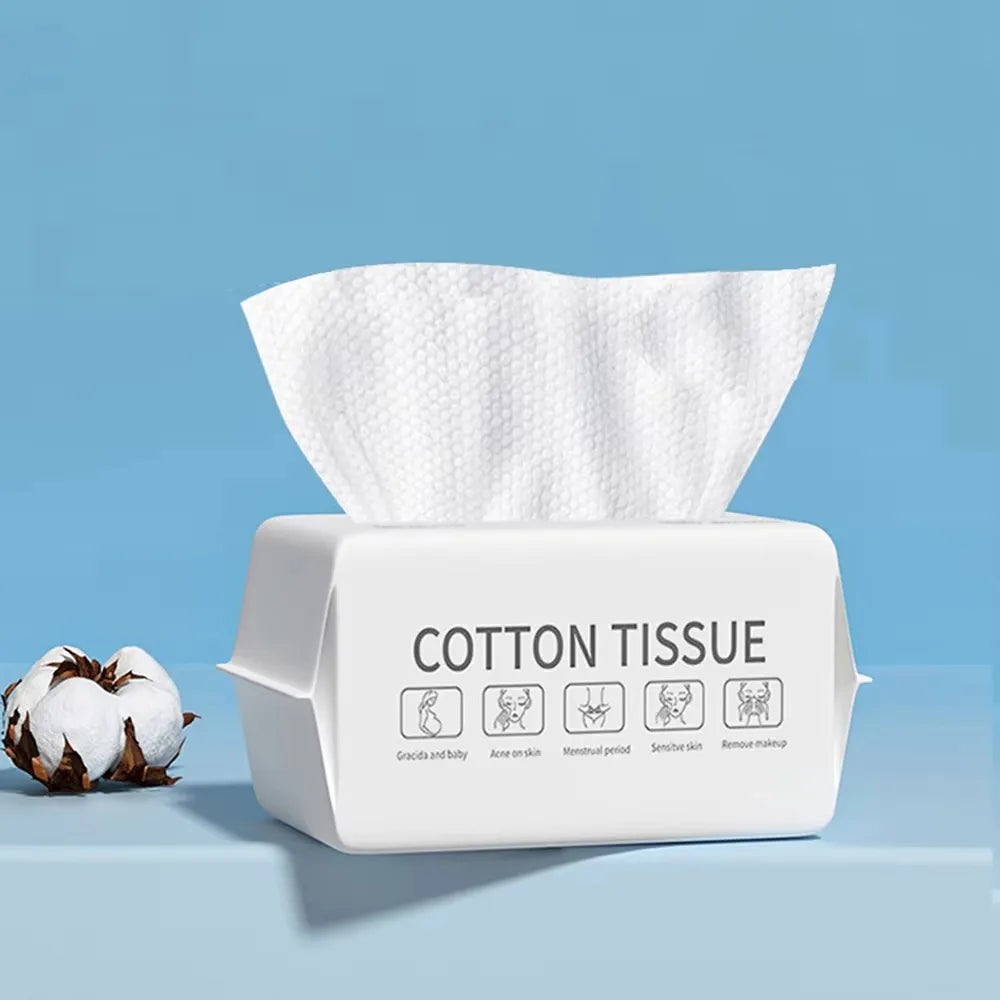 A white box of disposable cotton tissue with icons indicating uses for acne, menstrual period, sensitive skin, and makeup.