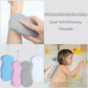 A child is using a 3D cartoon embossing clean sponge exfoliating brush on their foot in a bathtub.