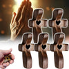 Several handcrafted wooden pocket crosses are shown, with one hand holding a small cross.