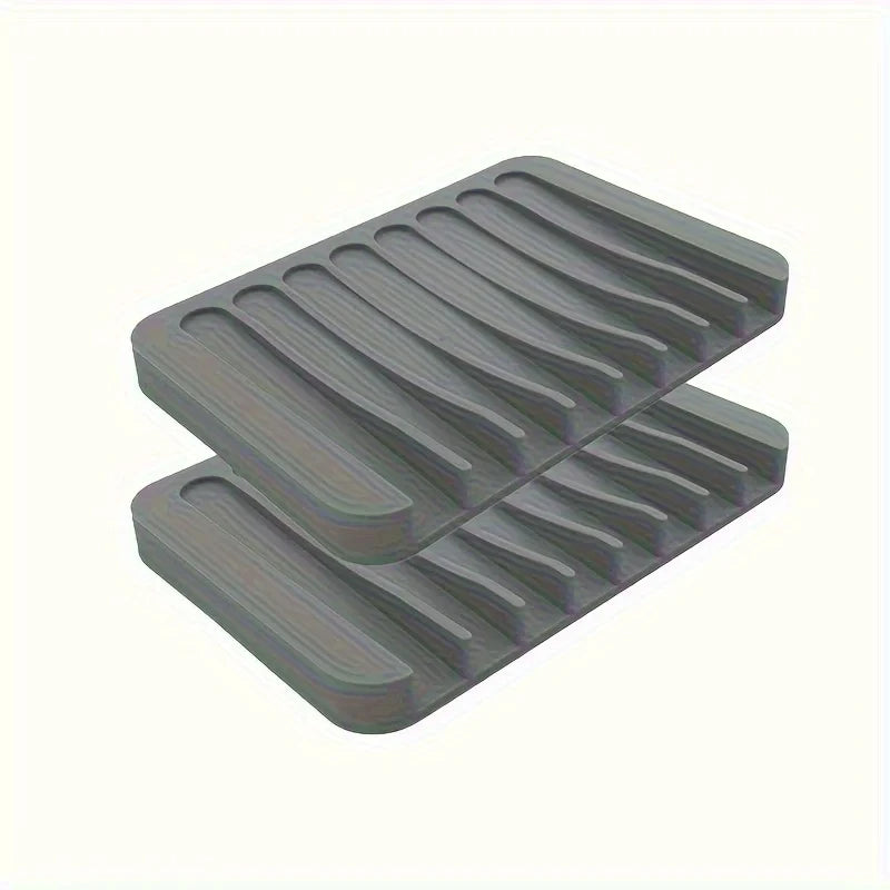 A stack of gray silicone soap dishes with anti-slip bases.