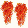 A pair of vibrant orange artificial flower garlands hanging down.