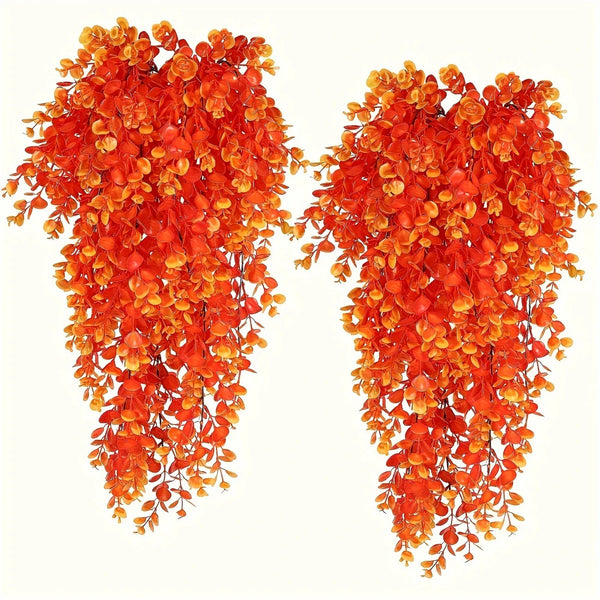 A pair of vibrant orange artificial flower garlands hanging down.