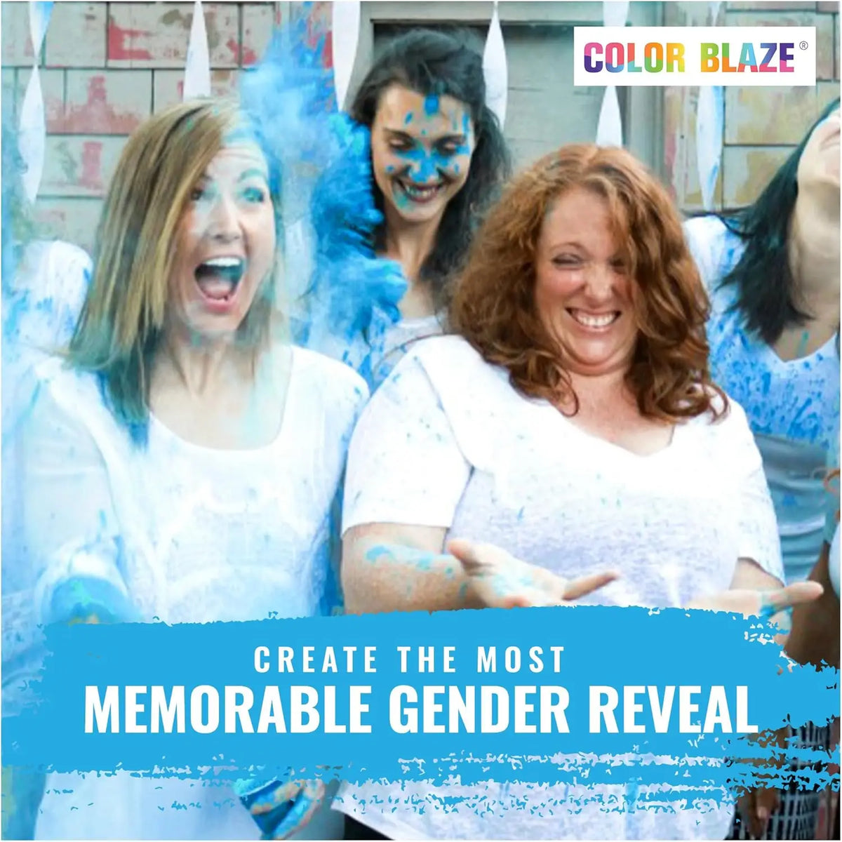 Three women laughing and covered in blue color powder celebrating a gender reveal event.