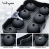 A black silicone ice mold tray with multiple spherical molds for whiskey and cocktails.