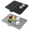 Black silicone dish drying mat with a built-in drain lip and two white mugs