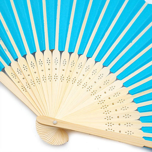 A hand held bamboo and paper folding fan with blue and cream colored blades.