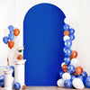 A blue arch backdrop decorated with balloons in shades of blue, white, and orange.