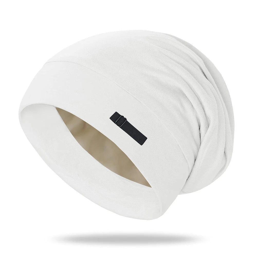 A white, soft night cap with a gathered design is shown from a slight angle.
