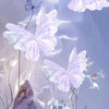 A close-up of delicate, translucent purple and white butterfly decorations floating against a soft light background.
