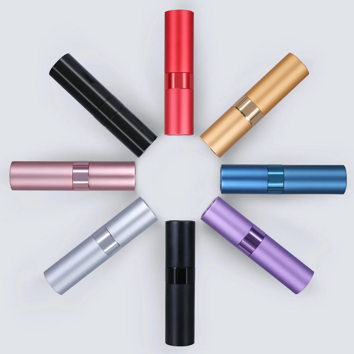 A collection of portable refillable perfume spray bottles in various colors including black, red, gold, rose pink, blue, silv