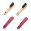 Un set de deux brosses nettoyantes multifonctionnelles, une beige clair et une rose, montrées en diagonale.