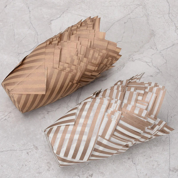 A pile of 50-piece tulip cupcake liners made of brown and white striped paper.