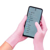 Pink disposable nitrile gloves are shown wearing a smartphone displaying a menu interface.