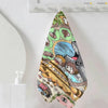 A triangular towel featuring Totoro cartoon characters and forest elements hanging on a white surface.