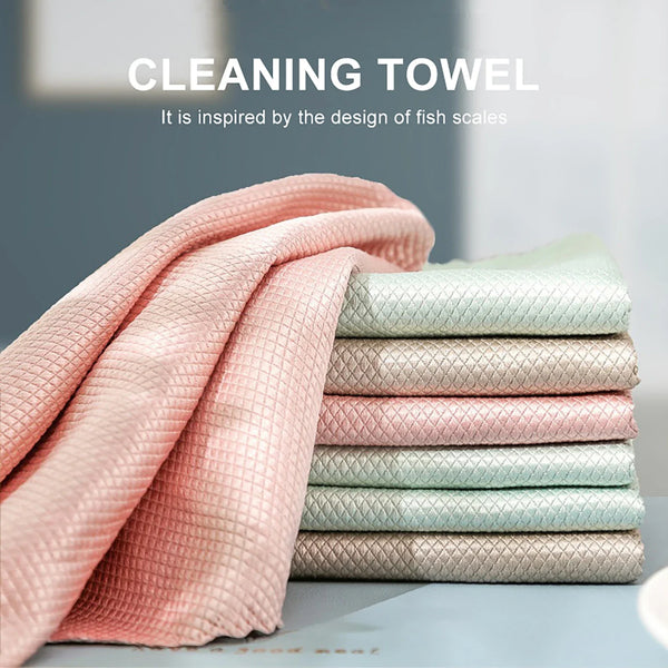 A stack of pink and mint green reusable microfiber cleaning towels inspired by the design of fish scales.