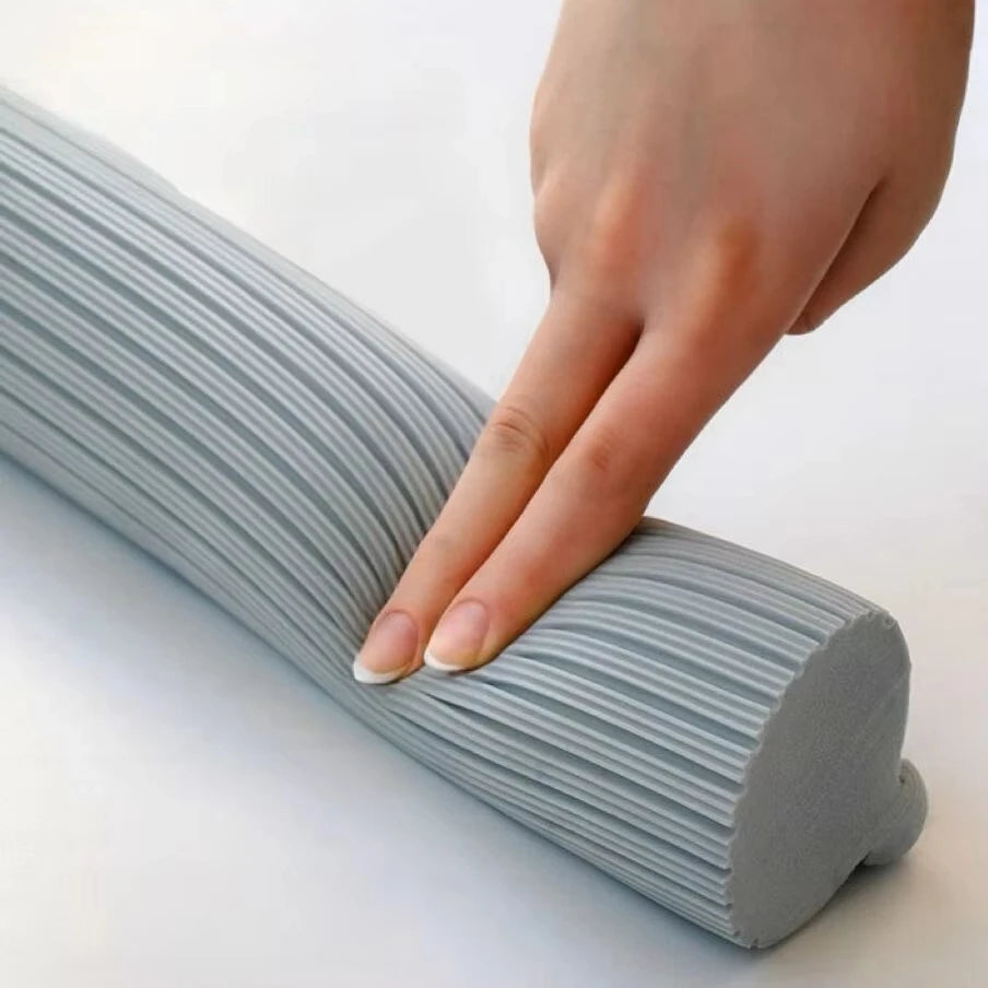 A hand is squeezing a replacement sponge mop head with a squeeze action, showing the ribbed gray product.