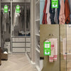 A close-up view of hanging moisture absorber bags for wardrobes in a modern closet setting.