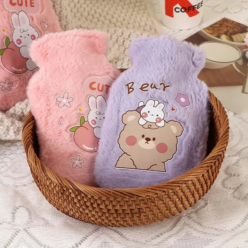Two plush cartoon hot water bottles, one pink and one purple, are shown in a woven basket.