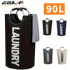 Black extra-large waterproof laundry basket with padded handle and a gray cloth hanging on the side.