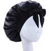Black silky satin sleep bonnet tied in a bow displayed on a white mannequin head.