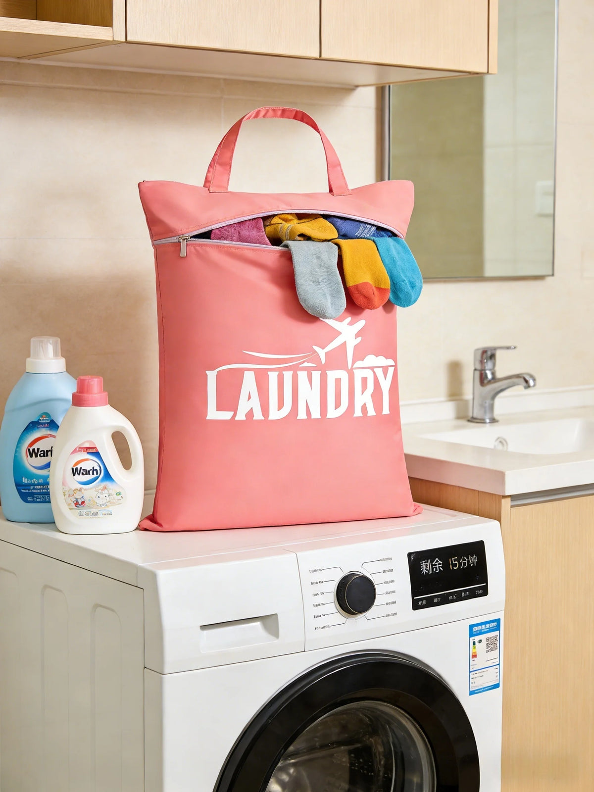 A pink laundry bag filled with colorful clothes rests on top of a white washing machine.