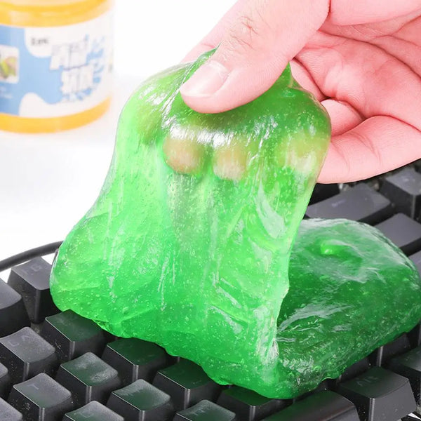 A hand is squeezing a bright green gel product onto a black Lego-style grid.