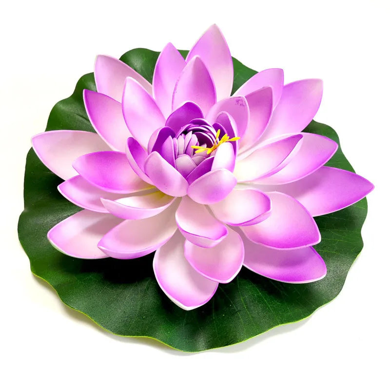A vibrant pink artificial lotus flower blooming on a green leaf.