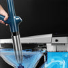 A hand holds a blue and silver heavy-duty stainless steel drain blaster kit being used to clean a glass bowl.