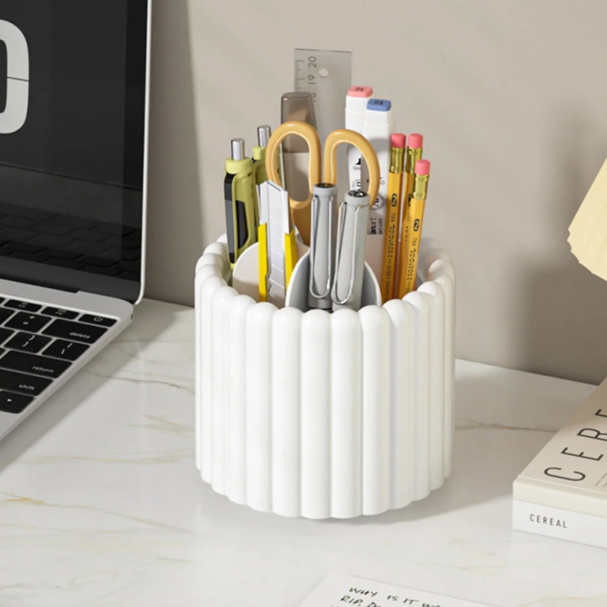 A white cylindrical organizer holding various makeup brushes and tools.