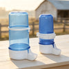 A clear and blue plastic bird drinking trough with a white base is shown on a wooden surface.