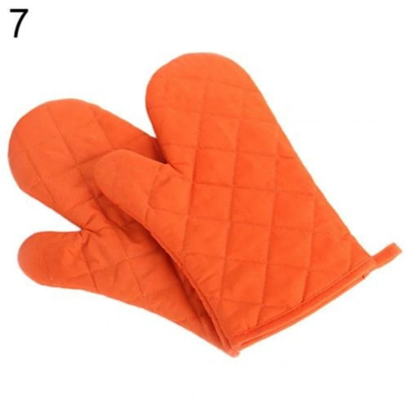 Orange quilted heat resistant oven mitts shown from the palm side.