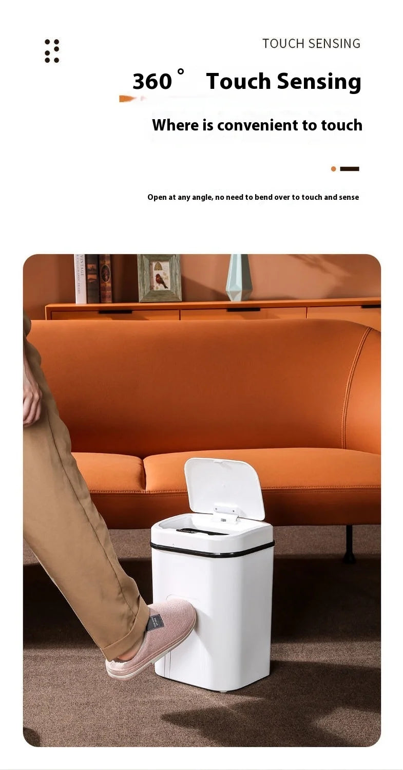 A white touchless sensor trash can is shown on a carpeted floor next to a person's leg.