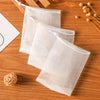 Three clear mesh bags filled with bulk soap are displayed on a wooden surface.