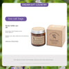 A brown glass candle jar labeled Sea salt Sage with a wooden box and product description