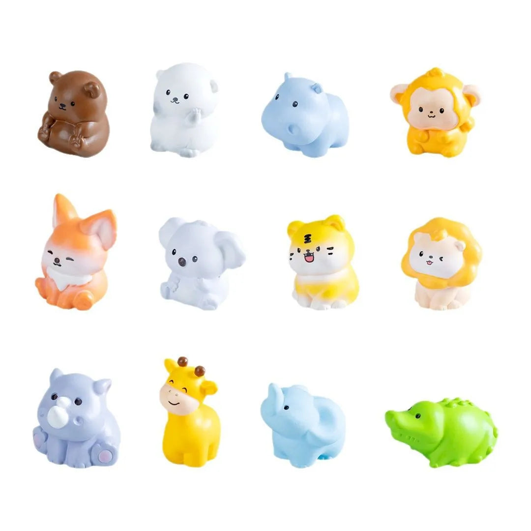 A collection of mini resin cartoon animal figurines in various colors including brown, white, blue, yellow, and green.