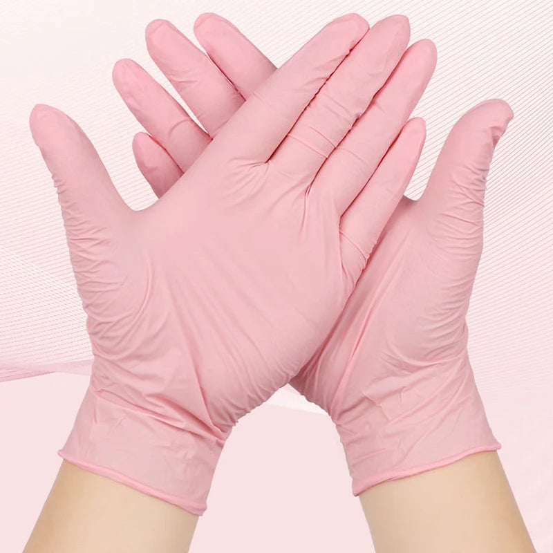 A pair of pink nitrile cleaning gloves are shown, folded and held together by the fingers.