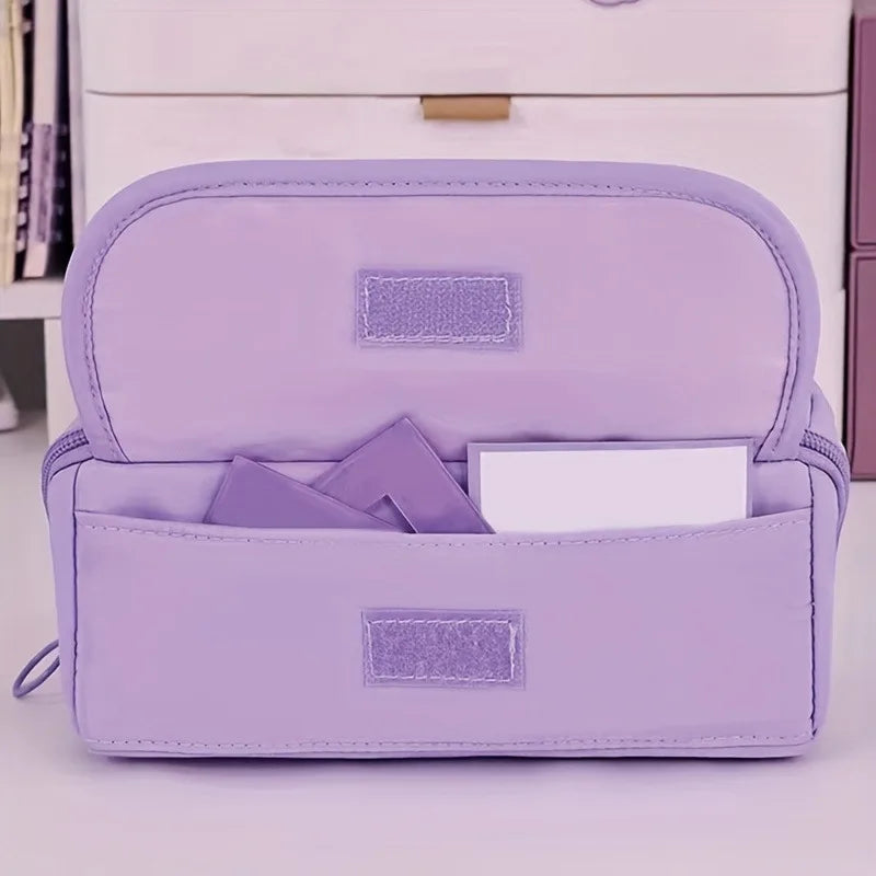 A lavender multi-compartment pencil case organizer with a zippered closure and internal pockets.