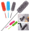 A set of four telescopic electrostatic microfiber dusters in red, blue, gray, and green with stainless steel handles.