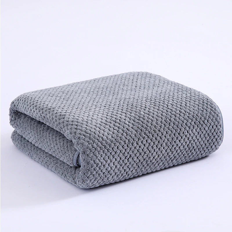 A folded gray thickened microfiber bath towel.