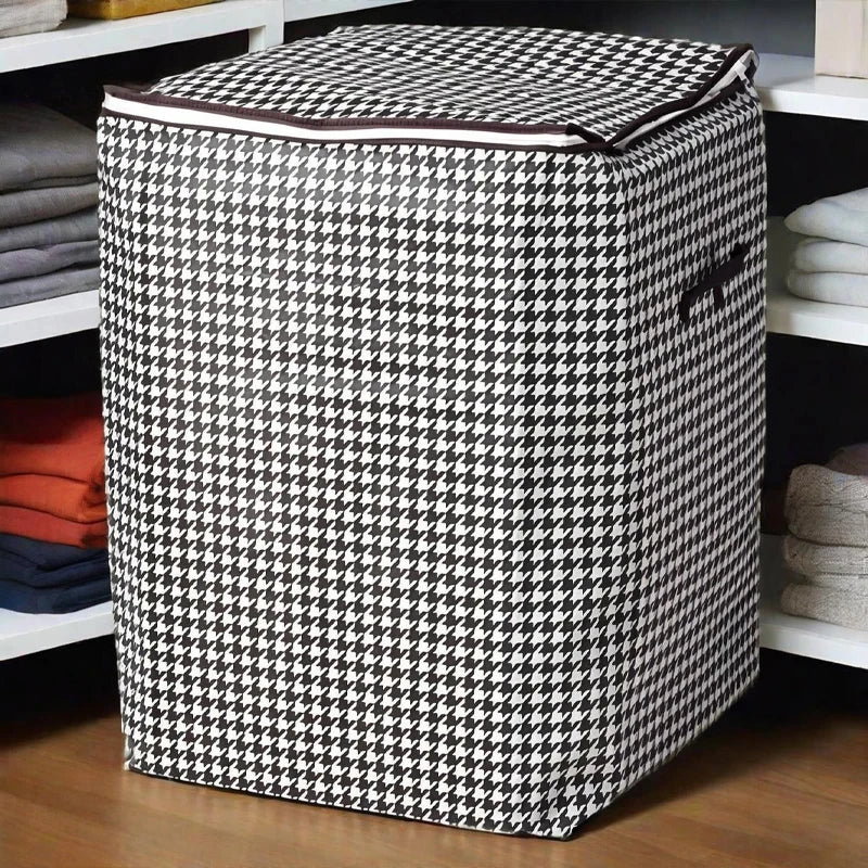 A checkered fabric foldable clothing storage bag sitting on a wooden shelf.