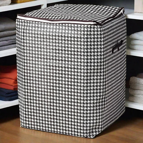 A checkered fabric foldable clothing storage bag sitting on a wooden shelf.