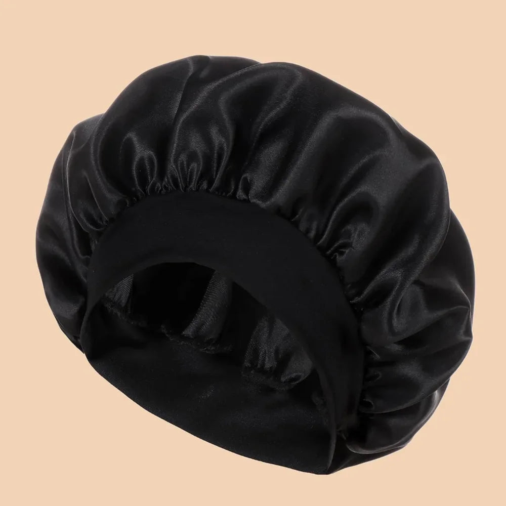 A black satin wide brim shower cap is shown from above.