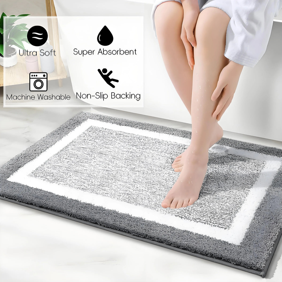 A person's legs are shown stepping onto a gray microfiber non-slip bath mat on a white floor.