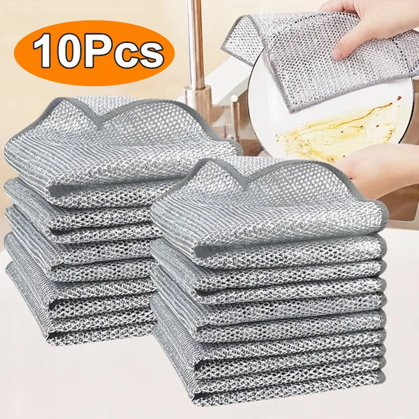 A stack of ten reusable gray and white microfiber dishcloths is shown next to a hand using one cloth for cleaning.