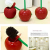 A red decorative cherry-shaped toilet brush set with a green handle and bristles.