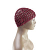 A hand-crocheted mesh hair net cap in deep red is displayed on a mannequin head.