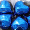 A set of shiny blue heart-shaped foil balloons displayed on a dark surface.