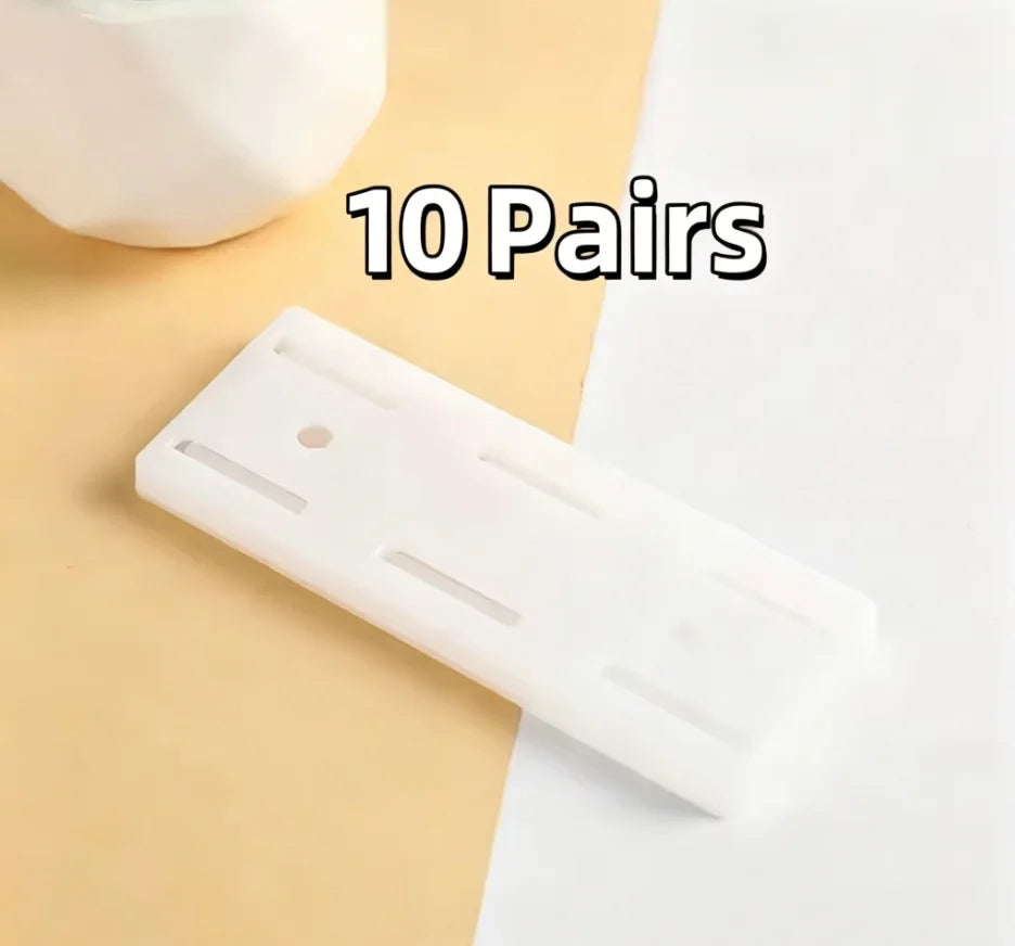 A white self-adhesive desktop cable organizer holder is shown on a light background.