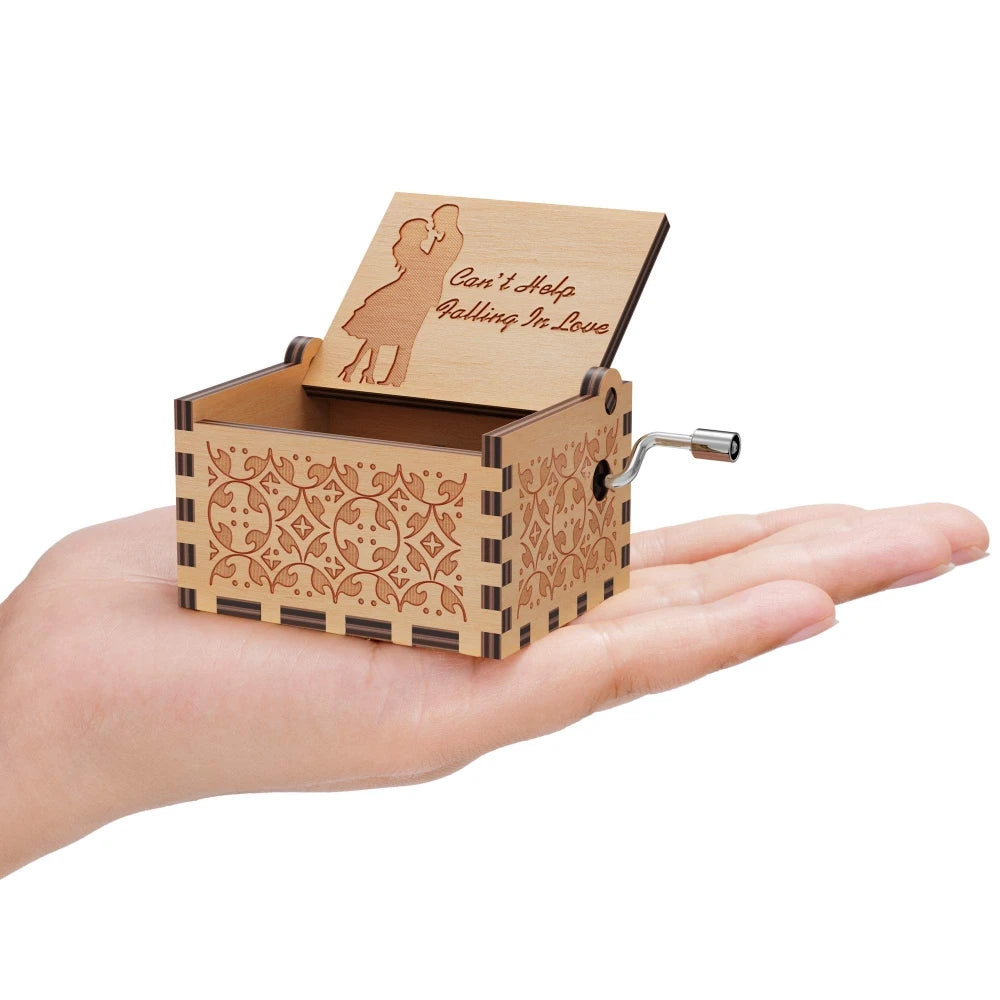 A vintage engraved wooden music box with a lid featuring a silhouette of a woman and a message inside.