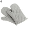 A pair of gray quilted heat resistant oven mitts shown from the side.
